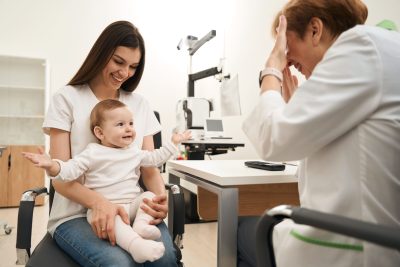 baby-sitting-on-mother-lap-in-ophthalmologist-offi-2023-11-27-04-58-59-utc-scaled
