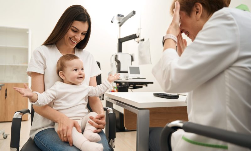 baby-sitting-on-mother-lap-in-ophthalmologist-offi-2023-11-27-04-58-59-utc-scaled