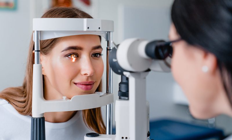 Eye doctor with female patient during an examination in modern clinic