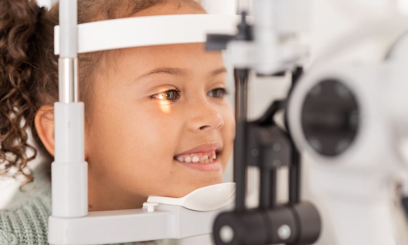 Vision, test and girl for eye exam in the opthalmologist office with equipment for glasses. Optics, examination and female child testing for eyecare health or wellness for optometry for healthcare.